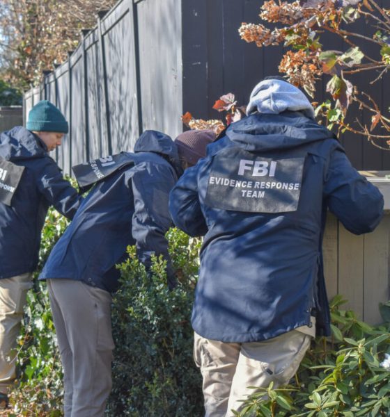 FBI agents in jackets examining a hedge during an evidence response operation. — national violent crime decline
