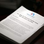 Stack of papers advocating for expanded healthcare for Florida's families, emphas — florida medicaid disenrollment lawsuit