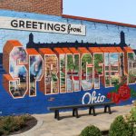 Colorful mural reading 'Greetings from Springfield, Ohio' with various images a — haitian tps expiration northwest florida