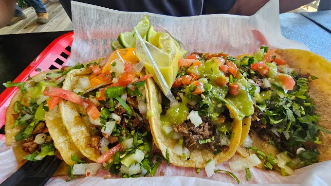 Taqueria El Asador Three carne asada tacos topped with salsa and cilantro