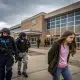 Girl escorted past armed officers outside school building