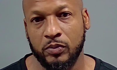 Bald man with beard in mugshot-style photo