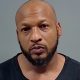 Bald man with beard in mugshot-style photo