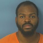 Mugshot-style portrait of bearded man in orange uniform — Pensacola meth trafficking guilty plea