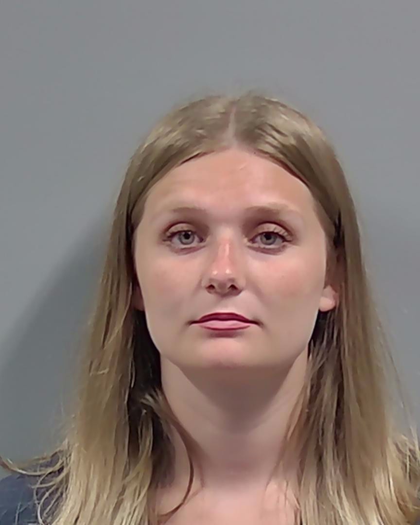 Portrait of a woman against a plain gray background