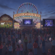 Crowd at the Pensacola Interstate Fair 2026 entrance featuring concert lineup and carnival rides.