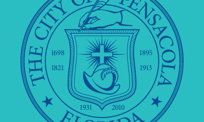 Seal of the City of Pensacola featuring a hand holding a quill and various symbols. — selection committee meetings