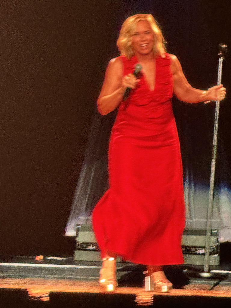 Woman in red dress performing on stage