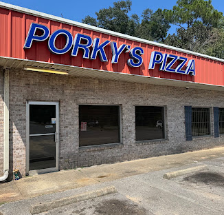Brick-front exterior of Porky's Pizza on Highway 29 in Cantonment, Florida, with red restaurant signage