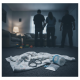 A dark living room scene showing a blanket, scissors, and suspected drugs on the floor, with two — Atmore Parents Arrested