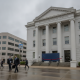 M.C. Blanchard Judicial Building with a large blue cover and a red ribbon, cloudy wea — Escambia County Courthouse Closure