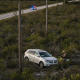 A Lincoln MKX abandoned in a field after a crash near Highway 97, with emergency responders — Highway 97 Crash Walnut Hill