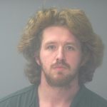 Mugshot-style portrait of a bearded man with long hair — Pensacola felon pleads guilty federal gun and drug charges