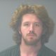 Mugshot-style portrait of a bearded man with long hair — Pensacola felon pleads guilty federal gun and drug charges