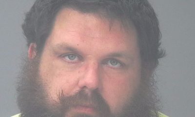 Mugshot-style portrait of a bearded man in yellow shirt — Jarod Christian Phelps hit and run