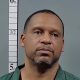 Mugshot-style portrait of man beside height chart — pensacola man sentenced federal drug charges