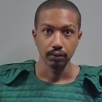 Man in green protective vest faces camera — Michael Anthony Hall Jr Arrest Cantonment
