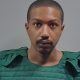 Man in green protective vest faces camera — Michael Anthony Hall Jr Arrest Cantonment