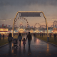 Families walking through a fairground at dusk, with colorful lights and a Ferris wheel in the — Pensacola Interstate Fair