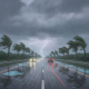 Dark storm clouds gathering over a wet highway illustrating the severe Pensacola weather forecast.