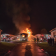 Flames engulf a mobile home in Cantonment as firefighters respond to the incident at night. — incendio en Cantonment