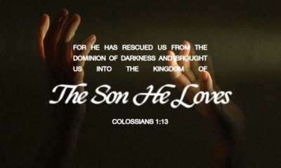 Colossians 1 13 meaning displayed over raised hands in a dark, dramatic scene — Colosenses 1 13 significado