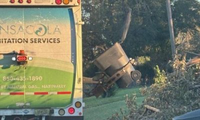 A truck from Pensacola Sanitation Services collecting storm debris after Hurricane I — Pensacola Hurricane Isaias recovery