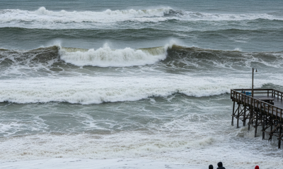 Large waves breaking along the shoreline during a Pensacola Beach high surf advisory.