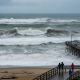 Large waves breaking along the shoreline during a Pensacola Beach high surf advisory.