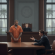 A courtroom scene showing a man in an orange jumpsuit standing before a judge, with a lawy — Daniel Bookout Milton Florida