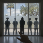 Silhouettes of five people stand behind a glass wall as a hand points toward th — Deshawn Donson Pensacola Armed Robberies
