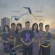 A group of people wearing purple ribbons stands together, symbolizing Domest — Domestic Violence Awareness Month Pensacola