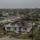 Severe damage from Hurricane Isaias in Pensacola, with a roof torn off a house and eme — Hurricane Isaias Pensacola Damage