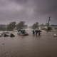 Residents wade through floodwaters during a severe storm in Escambia County, with damage — Escambia County Hurricane Watch