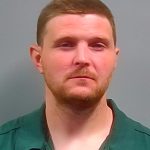 Man in green collared shirt against gray background — West Nine Mile Road Bank Robbery — robo a banco en Pensacola