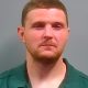 Man in green collared shirt against gray background — West Nine Mile Road Bank Robbery — robo a banco en Pensacola