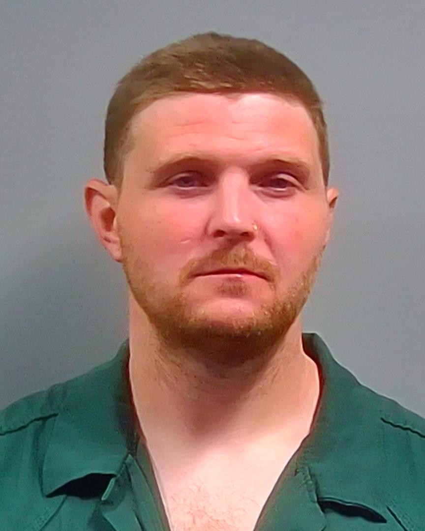 Man in green collared shirt against gray background — West Nine Mile Road Bank Robbery — robo a banco en Pensacola