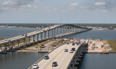 View of reopened Pensacola Bay Bridge with vehicles traveling and construction activity visib — Pensacola Bridges Reopened
