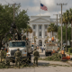 Workers and Florida National Guard personnel clear storm debris from a street in Pensacola, wit — Pensacola Storm Recovery