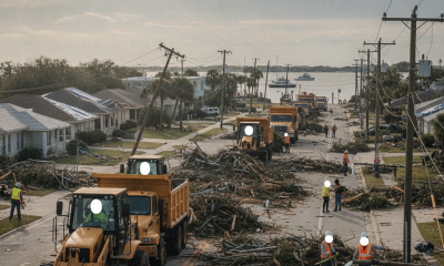 Heavy machinery clearing debris from a street in Pensacola after Hurricane Isaias, w — pensacola hurricane isaias recovery