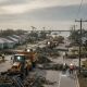 Heavy machinery clearing debris from a street in Pensacola after Hurricane Isaias, w — pensacola hurricane isaias recovery