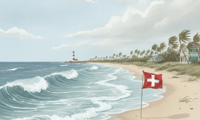 Waves crashing on a beach with a Swiss flag in the foreground and a lighthouse in the background — Tropical Cyclone Isaias